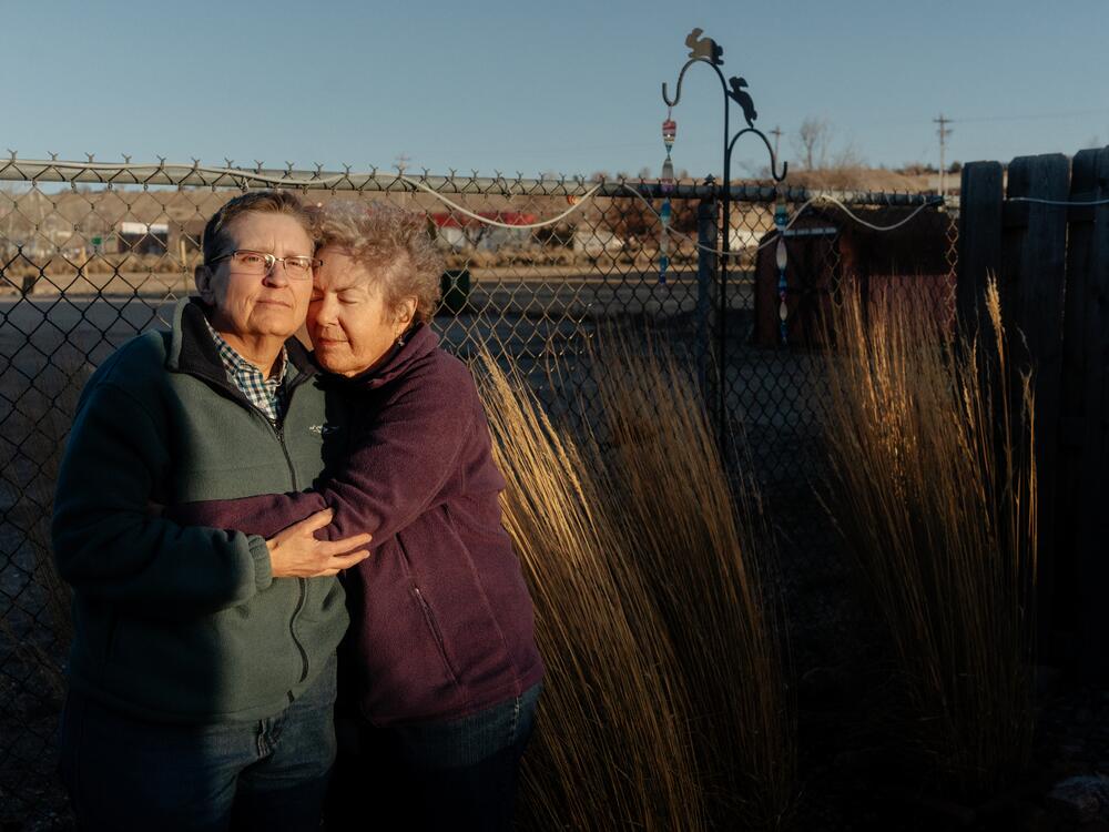 Janet de Vries (left) and Leanne Woodfill stand in the backyard of their home in Casper, Wyo.