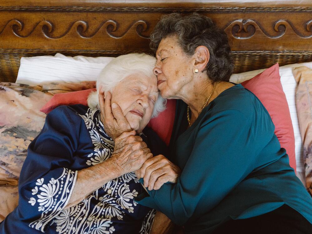 Lillian Faderman (right) holds Phyllis Irwin in their bedroom in their home in La Jolla, Calif.