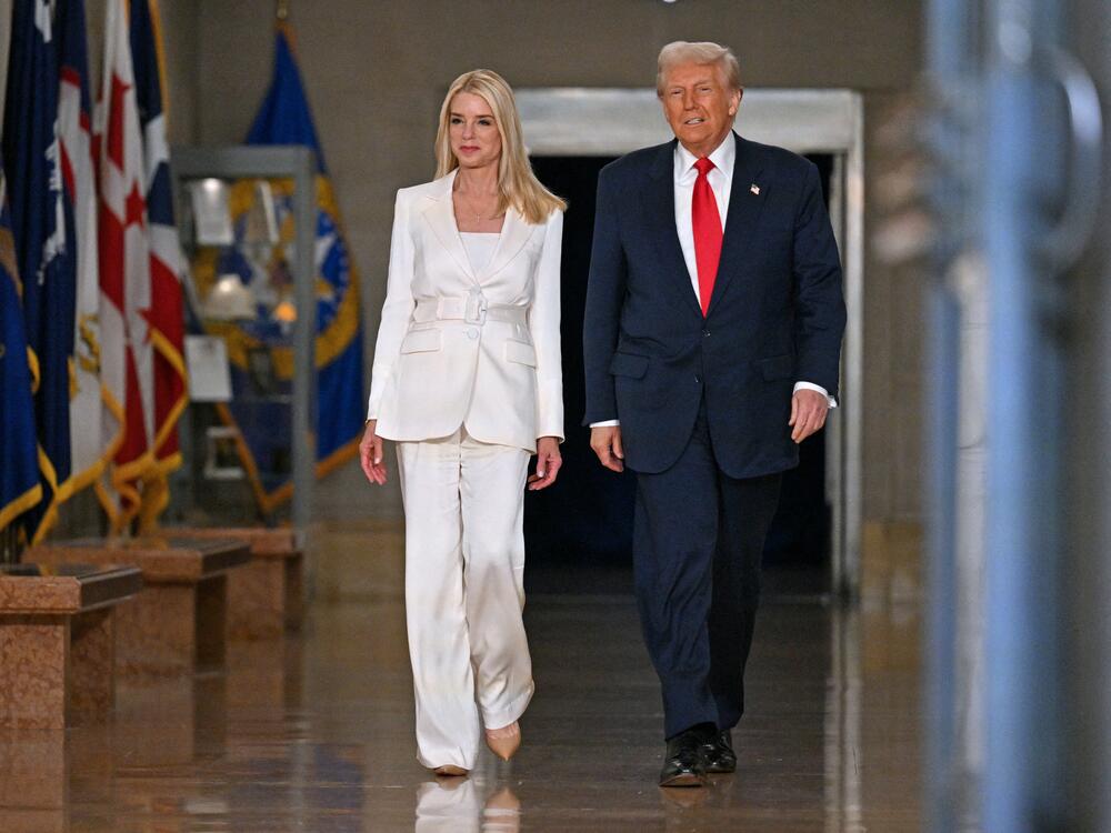 President Donald Trump and Attorney General Pam Bondi arrive to speak at the Department of Justice on March 14, 2025.