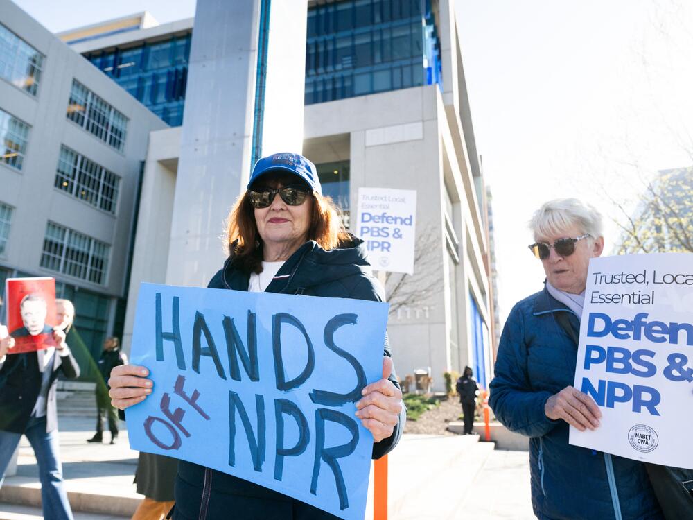 People participate in a rally to call on Congress to protect funding for PBS and NPR outside the NPR headquarters in Washington, DC, on March 26, 2025.