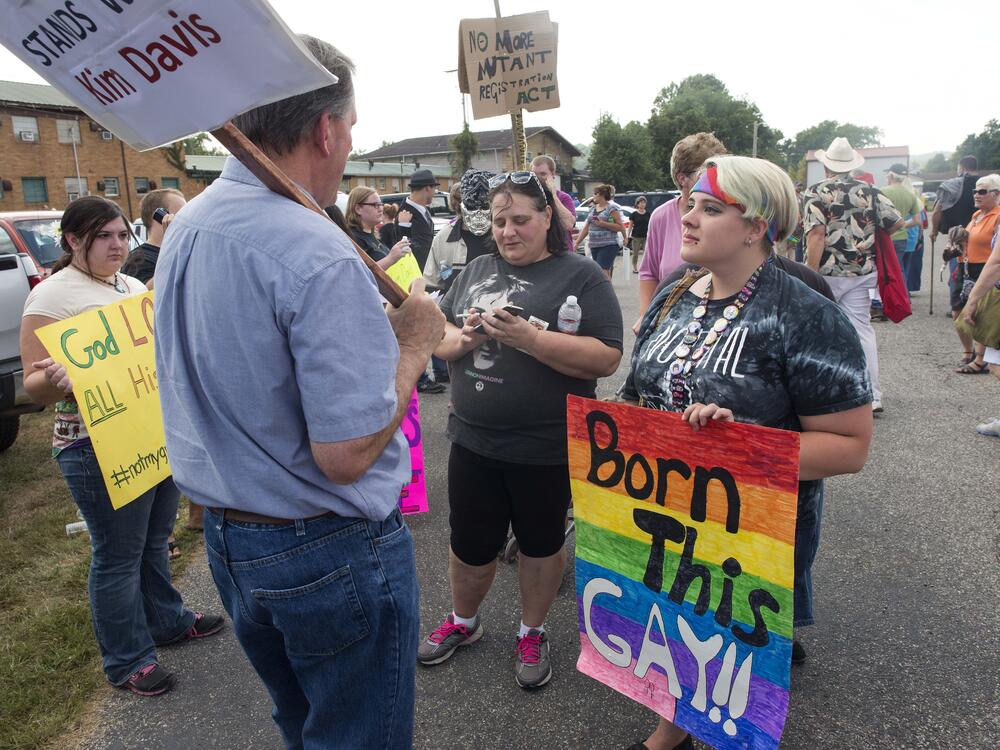 Same-sex marriage supporters speak with people leaving a rally in support of Rowan County Clerk of Courts Kim Davis  on Sept. 8, 2015, in Grayson, Ky.