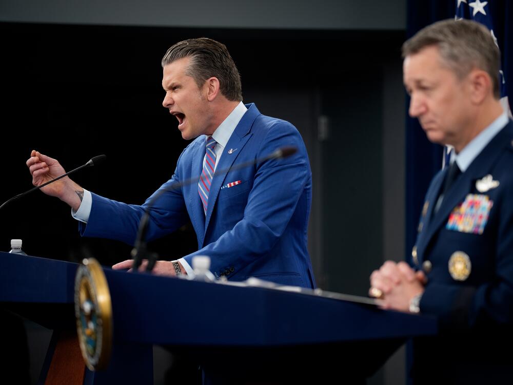 Defense Secretary Pete Hegseth (L), accompanied by Chairman of the Joint Chiefs of Staff Air Force Gen. Dan Caine (R), speaks during a news conference at the Pentagon on Thursday about the U.S. airstrikes against Iran's nuclear facilities.