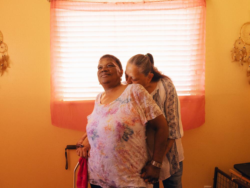 Cindy (right) and Jo embrace each other in their home in Blythe, Calif.
