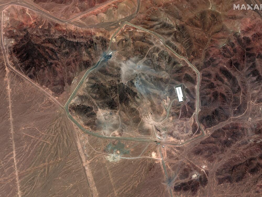 A satellite photo of Iran's Fordo fuel enrichment facility taken on June 24 shows debris (grey) from a U.S. strike employing several bunker-busting weapons. The Israeli Air Force destroyed additional roads and surface facilities in a subsequent strike.