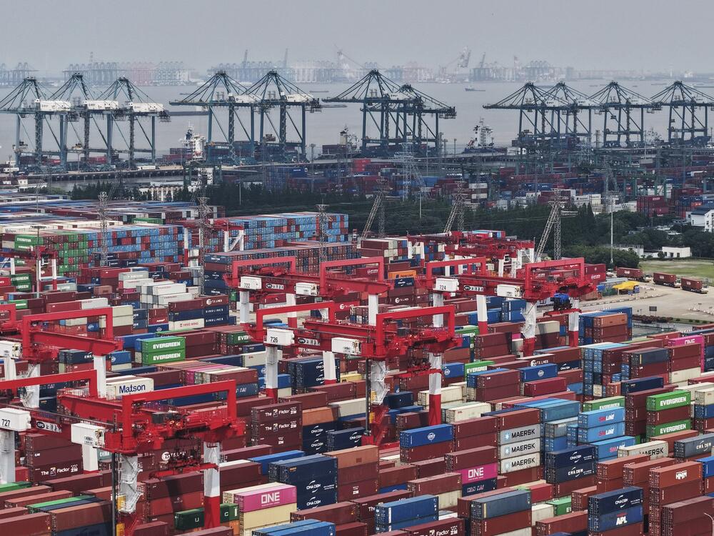 Trucks loaded with containers move through a port in Shanghai, China Monday, June 9, 2025.