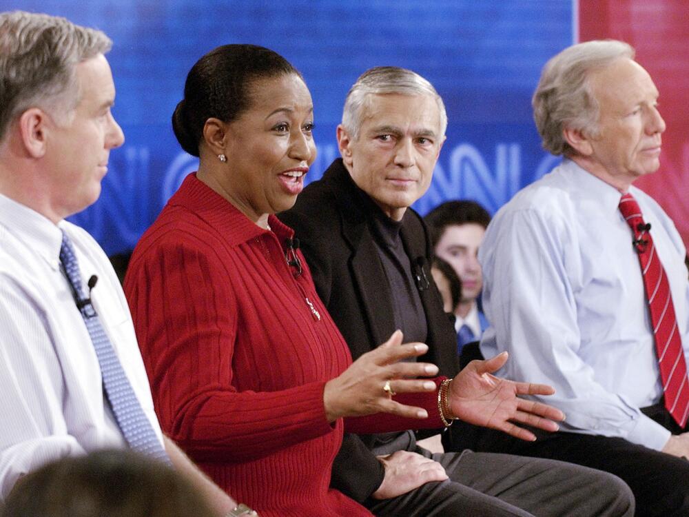 Then-Presidential candidate former senator Carol Moseley Braun (D-IL) (2nd from L) answers a question as Sen. Joe Lieberman (D-CT) (R), former Vermont governor Howard Dean (L), and Retired General Wesley Clark (3rd from L) during a debate sponsored by CNN Rock the Vote at historic Faneuil Hall November 4, 2003 in Boston, Massachusetts.