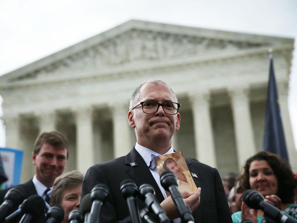 Plaintiff Jim Obergefell holds a photo of his late husband John Arthur as he speaks to members of the media after the U.S. Supreme Court handed down a ruling regarding same-sex marriage June 26, 2015, outside the Supreme Court in Washington, D.C. The high court ruled that same-sex couples have the right to marry in all 50 states.