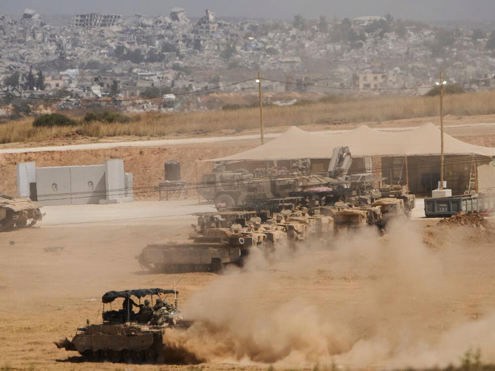 Israeli soldiers drive an armored vehicle at a staging area near the border with the Gaza Strip, in southern Israel, May 26.
