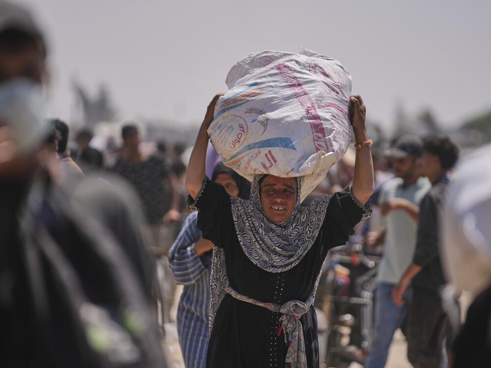 A Palestinian woman carries a bag of food delivered by the Gaza Humanitarian Foundation, a U.S.-backed organization, in Rafah, southern Gaza Strip, June 11.