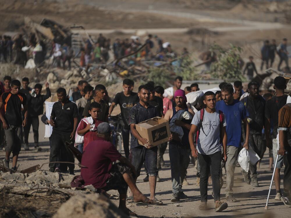 Palestinians carry food packages near a distribution site operated by the U.S.-backed Gaza Humanitarian Foundation in Khan Younis, southern Gaza Strip, Thursday.