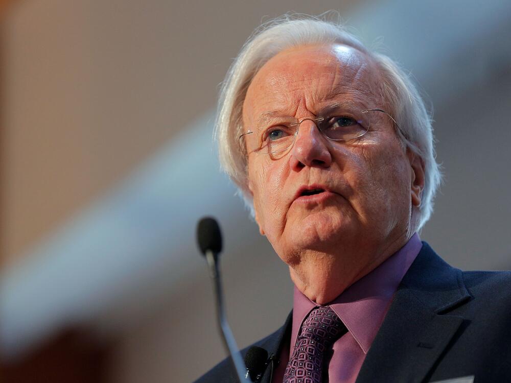 Journalist Bill Moyers moderates the 