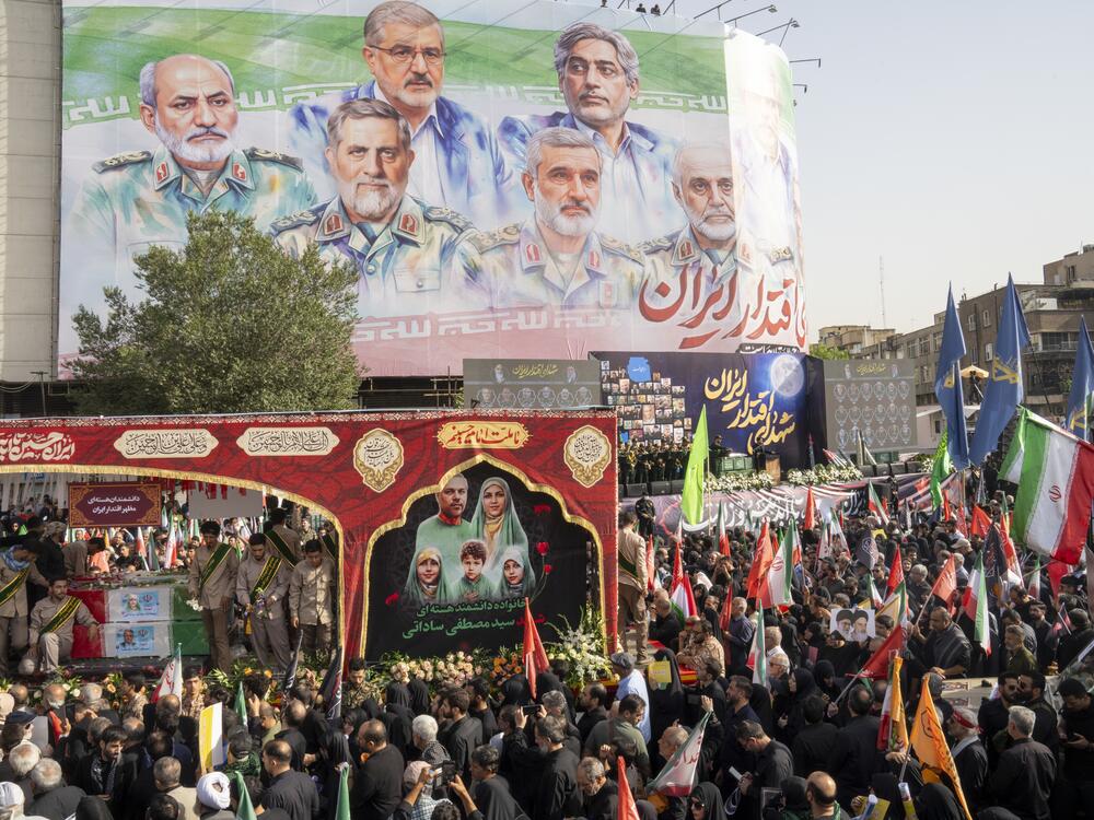 Thousands of Iranians attend the funeral ceremony Saturday for approximately 60 people killed in Israeli strikes on Iran, including high-ranking military officials, nuclear scientists, and civilians. Israel and Iran fought for 12 days before a ceasefire last Tuesday.