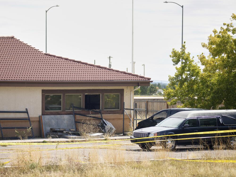 A hearse and van sit outside the Return to Nature Funeral Home in Penrose, Colo., on Oct. 6, 2023.