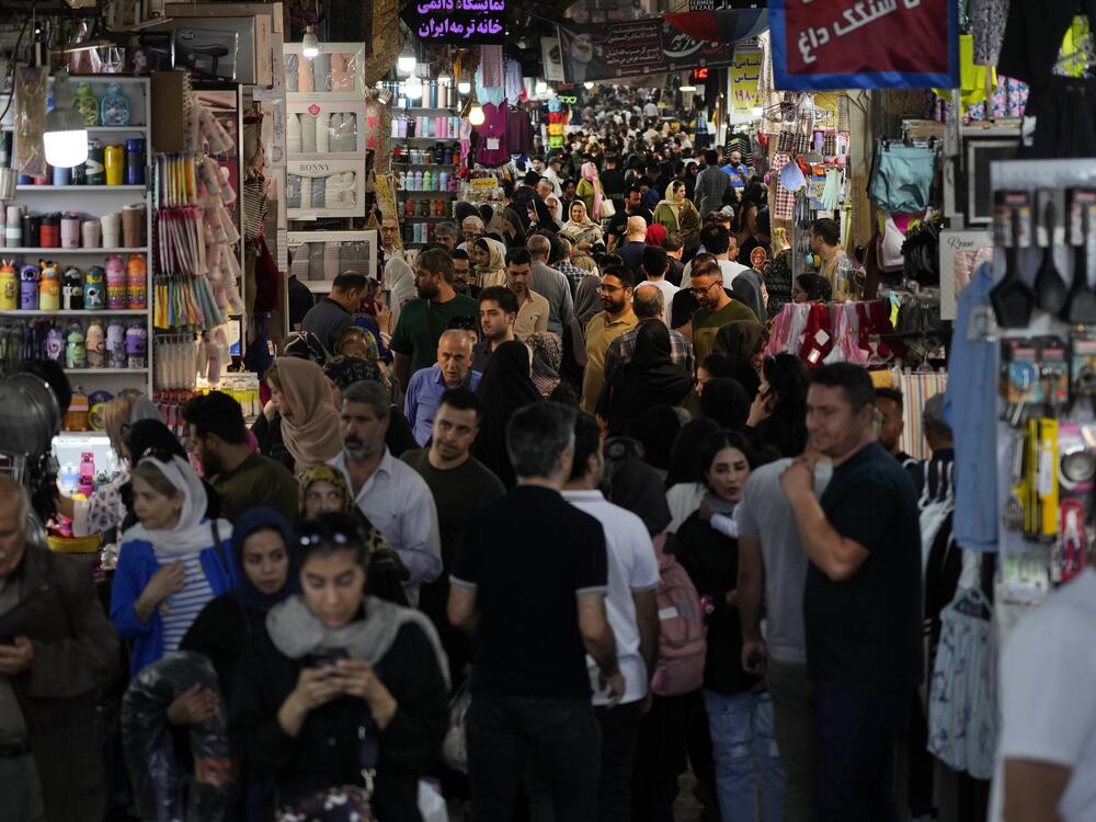 People walk through the old main bazaar of Tehran, Iran, on a Saturday night, Oct. 19, 2024.
