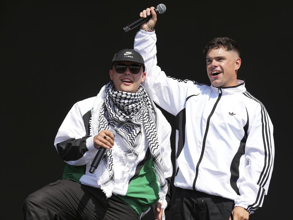 Liam Og, left, and Naoise O Caireallain of the hip hop trio Kneecap perform during the Glastonbury Festival in Worthy Farm, Somerset, England, Saturday, June 28, 2025. (Scott A Garfitt/Invision/AP)