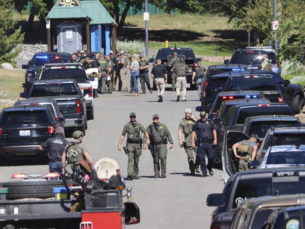 Law enforcement and emergency responders are shown on Sunday afternoon following reports of an ambush shooting attack on Canfield Mountain, in Coeur d'Alene, Idaho.
