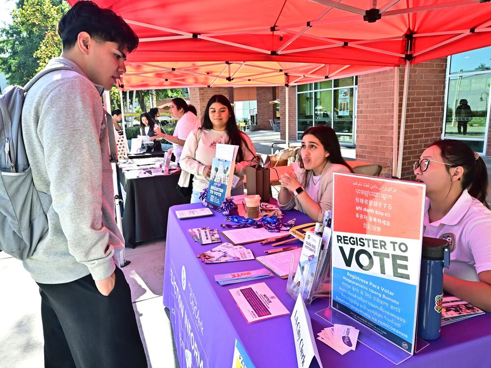Potential voters get information at a voter registration event on October 22, 2024 at Cal State Los Angeles in Los Angeles.
