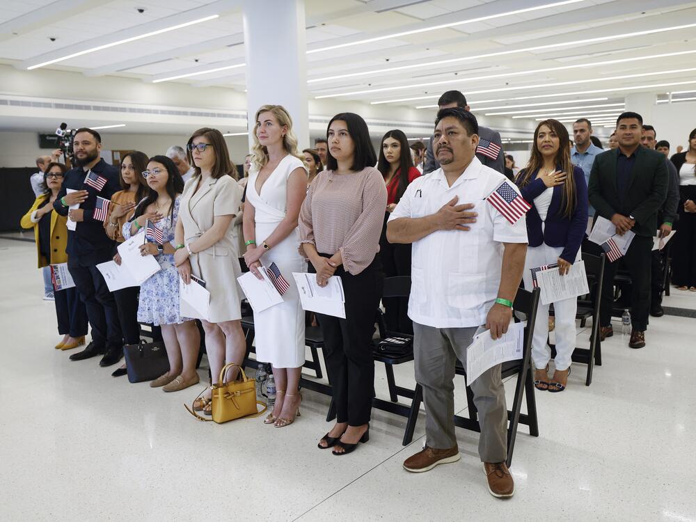 New U.S. citizens stand during a naturalization ceremony in Chicago on June 25, 2025. Newly naturalized citizens may fall through the cracks of the new citizenship verification tool built by the Department of Homeland Security.