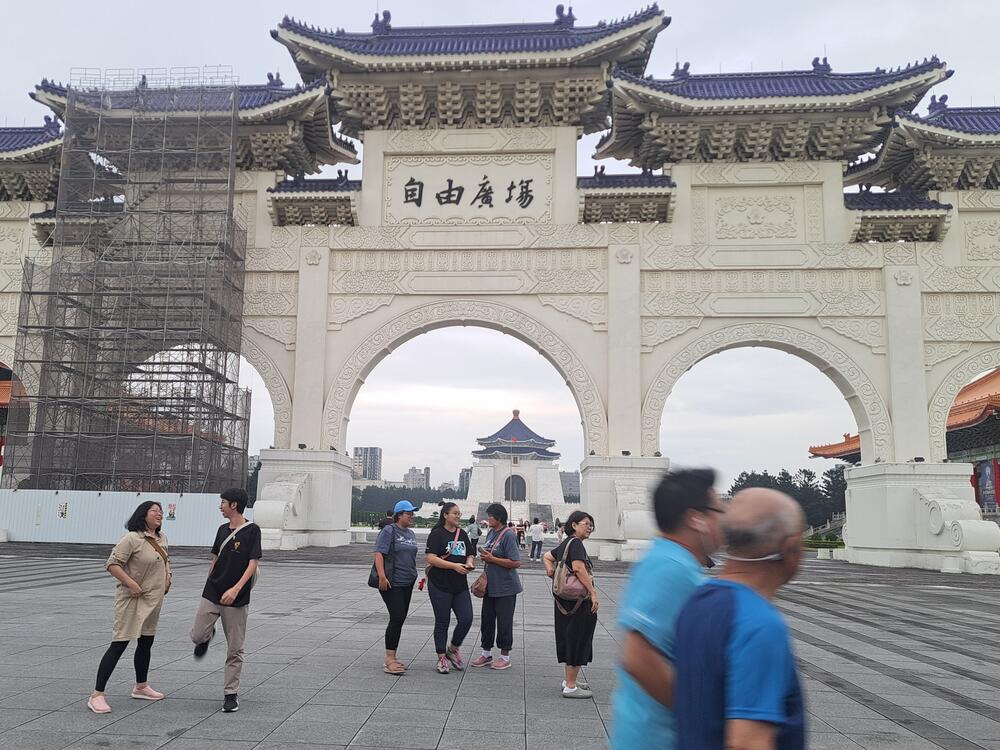 Taipei residents walk past the Liberty Square Arch in the city's downtown Zhongzheng district.