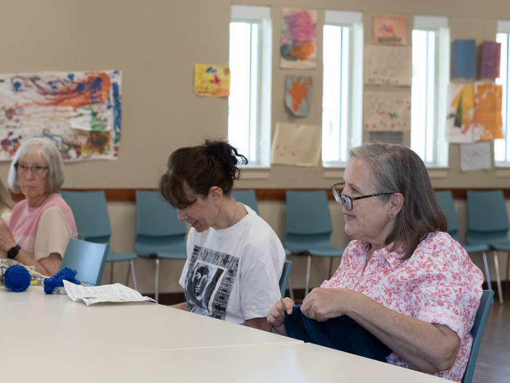 Lorraine Carter Salazar (right) works on a knitting project at a craft group she attends weekly at a Sacramento library branch.