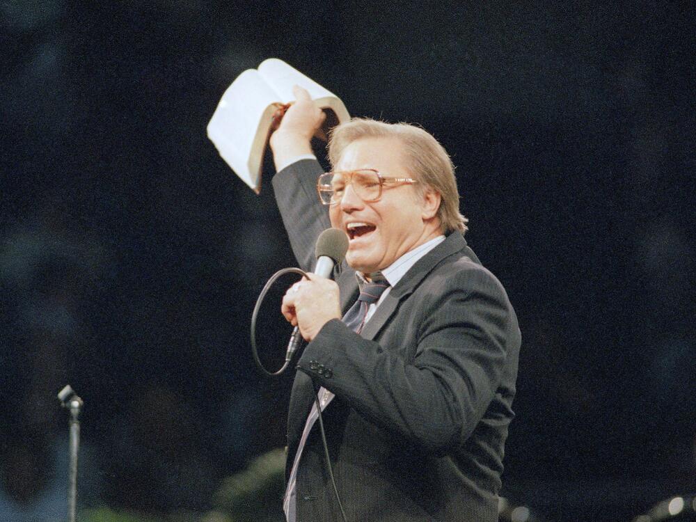 The Rev. Jimmy Swaggart gestures with the Bible at the Los Angeles Sports Arena during a service in Los Angeles in 1987.