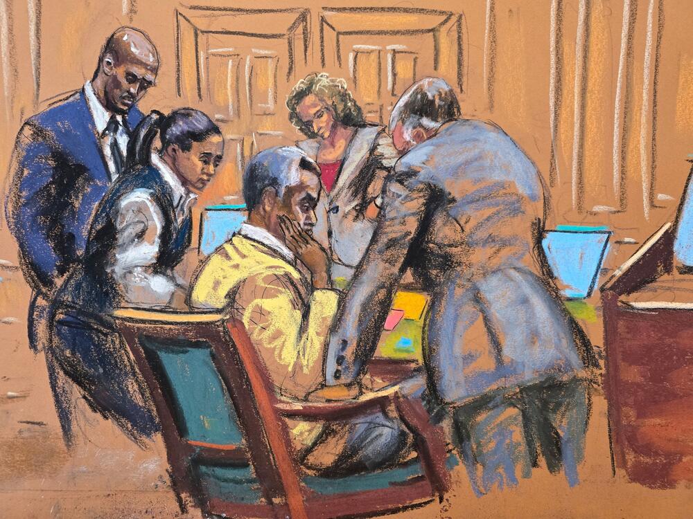 Defense attorneys confer with Sean Combs in this courtroom sketch. The jury began deliberations at Combs' sex trafficking trial in New York City on Monday.