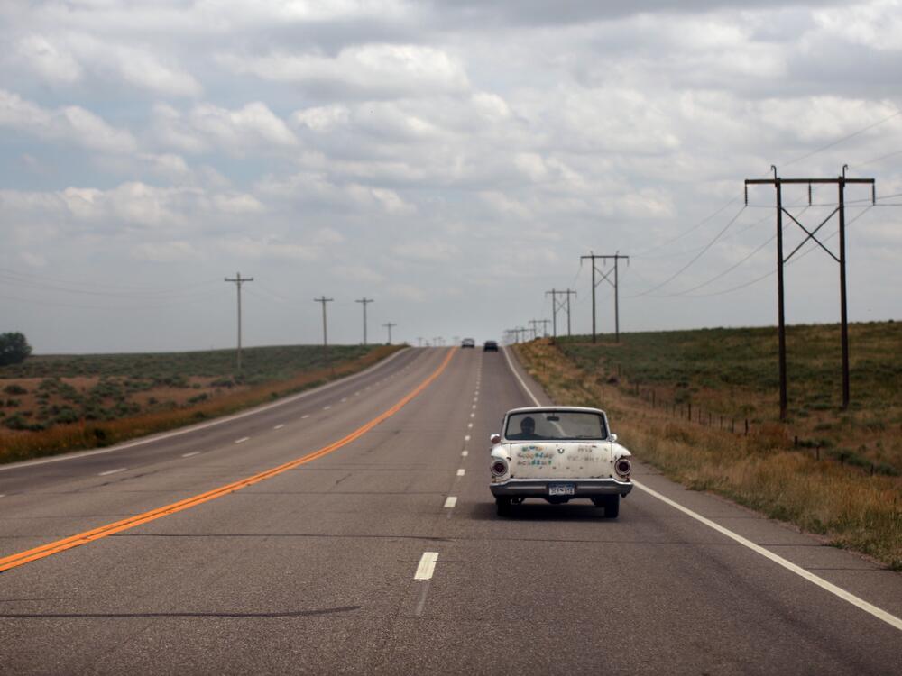 A man drives a vintage automobile down a highway June 27, 2007 in Colorado.