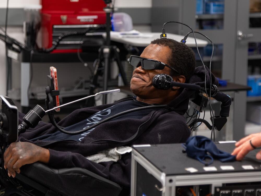 Phillip McKenzie, who was paralyzed from the neck down in a fall in 2012, uses a brain-computer interface developed by researchers at the University of Pittsburgh to navigate complex virtual tasks that simulate everyday activities,