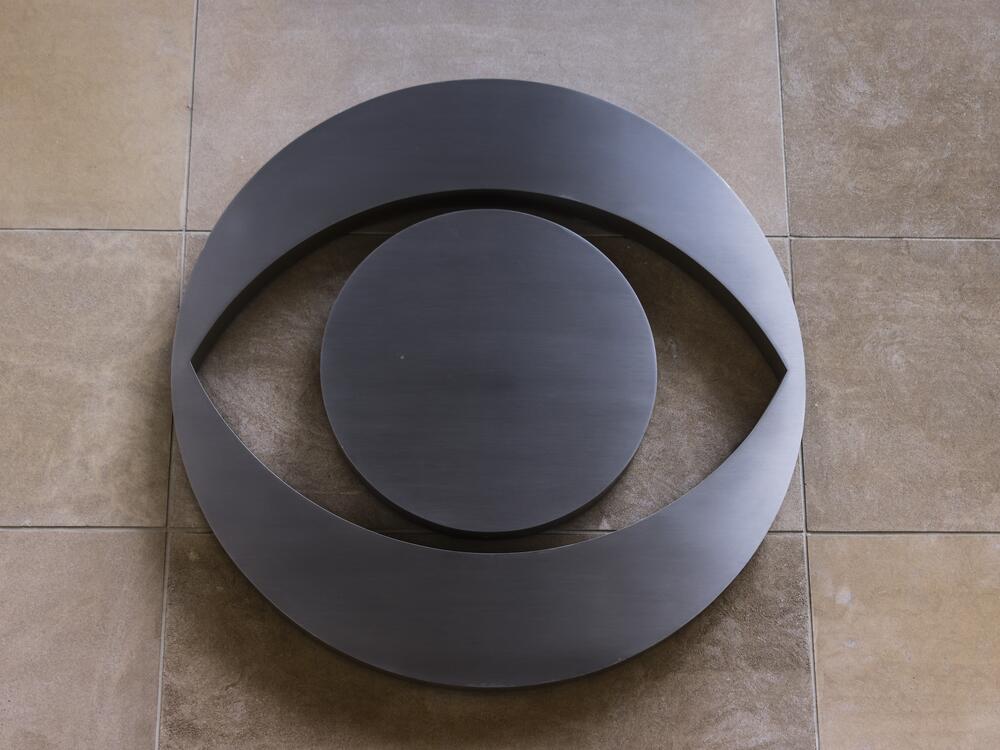 The CBS logo is seen on a building in Chicago. The network's parent company, Paramount Global, has agreed to pay $16 million for President Trump's future presidential library to settle a lawsuit he filed over the editing of a <em>60 Minutes </em>interview with former Vice President Kamala Harris during last fall's elections.