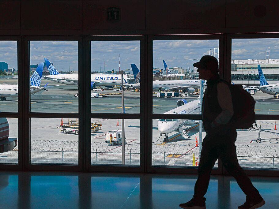 A traveler walks through Newark Liberty International Airport in early June. United Airlines says Newark was the most reliable airport in the New York City area in June — a remarkable turnaround after a wave of cancellations and delays in April and May.