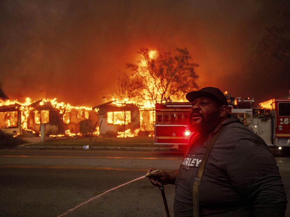 A resident of Altadena, Calif., during wildfires in January 2025. Wildfires are getting more extreme because of climate change. The Trump administration has taken down the website for the National Climate Assessment, which is the most comprehensive and authoritative source of information about how climate change is affecting all parts of the U.S.