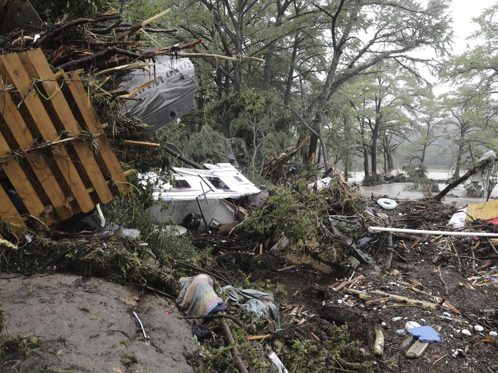 Damaged vehicles and debris are seen roped off near the banks of the Guadalupe River after flooding in Ingram, Texas, on Friday.