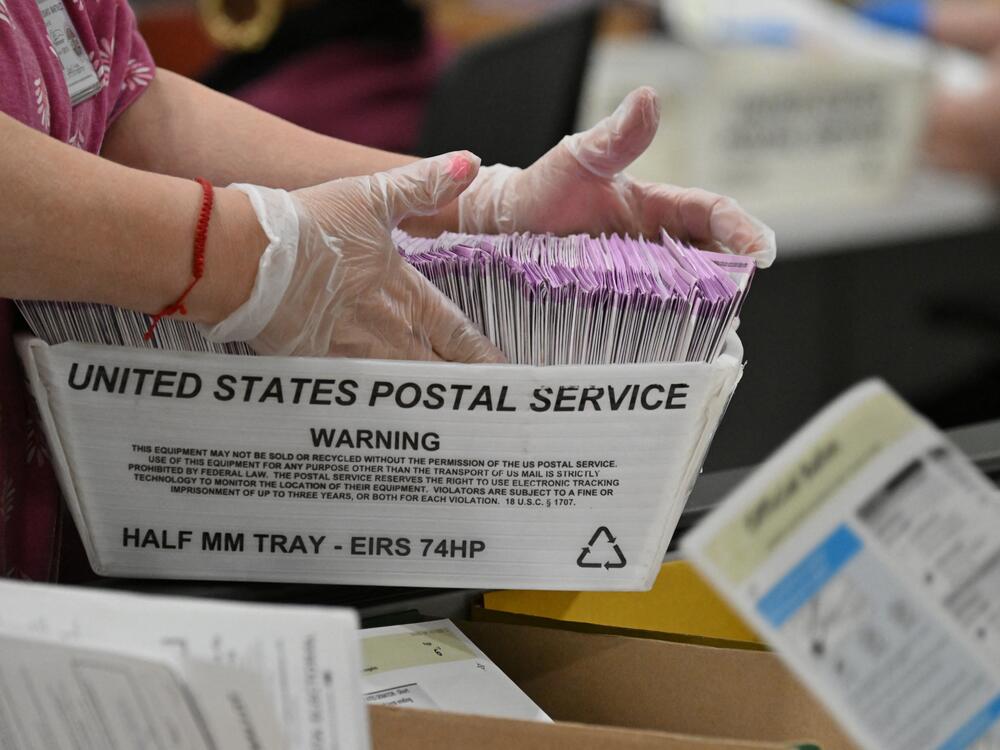 In this file photo, election workers prepare mail-in ballots for tallying at the Los Angeles County Ballot Processing Center on the eve of Election Day, Nov. 4, 2024, in City of Industry, Calif.