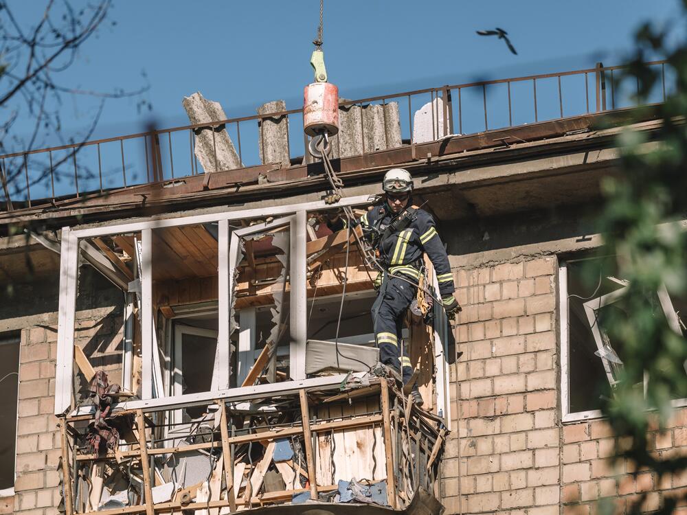 A rescue worker works at the site of a Russian air strike on a residential building in Kyiv, Ukraine.