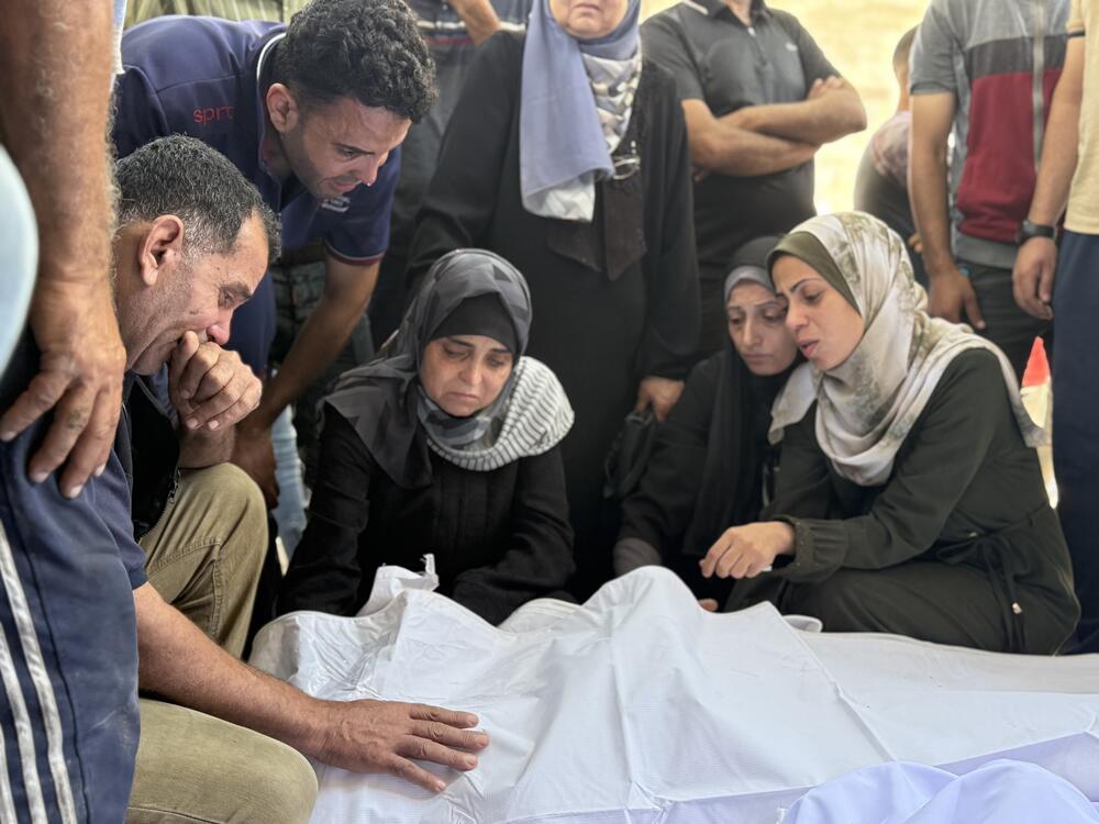 Relatives grieve over bodies of family members killed in an Israeli strike on a school sheltering displaced Palestinians near al-Shifa hospital in Gaza City on Thursday.