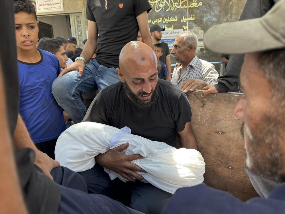 Relatives grieve over bodies of family members killed in an Israeli strike on a school sheltering displaced Palestinians near al-Shifa hospital in Gaza City on Thursday.