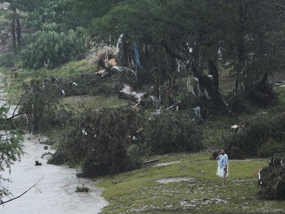 A man surveys damage left by a raging Guadalupe River n Kerrville, Texas.