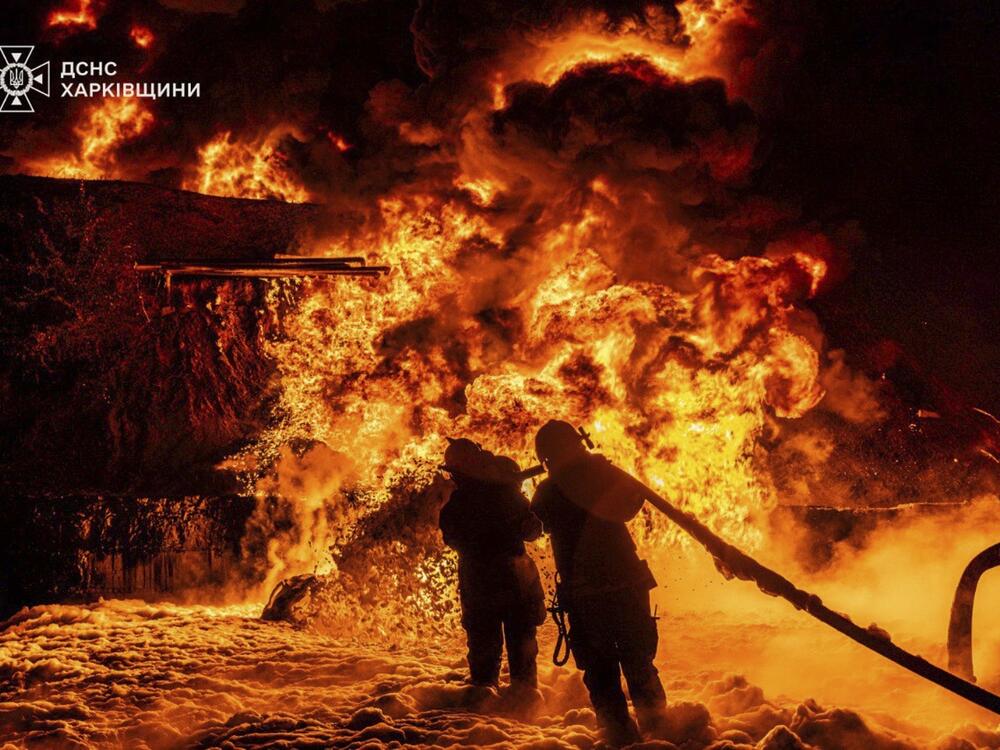 In this photo provided by the Ukrainian Emergency Service, emergency services personnel work to extinguish a fire following a Russian attack in Kharkiv region, Ukraine, Saturday, July 5, 2025.