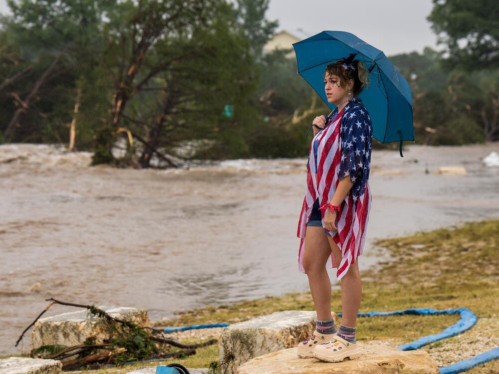 Kerrville resident Leighton Sterling watches flood waters along the Guadalupe River in Kerrville, Texas.