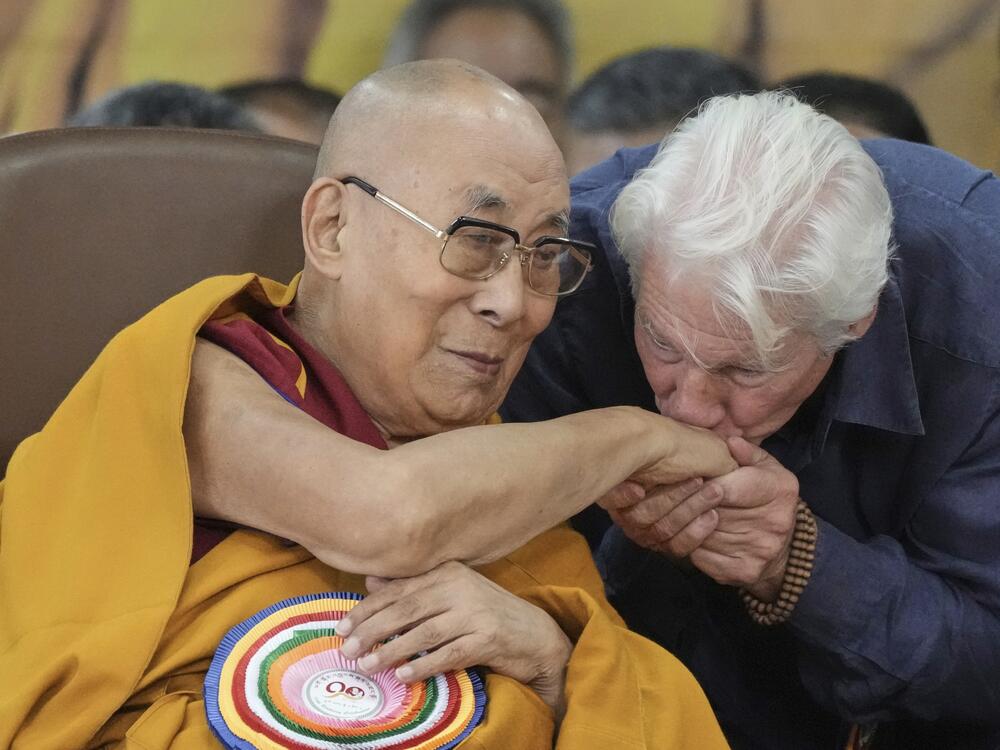Actor Richard Gere, right, kisses the hand of Tibetan spiritual leader the Dalai Lama at an event celebrating the Dalai Lama's 90th birthday in Dharamshala, India, Sunday.