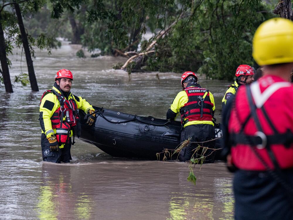 Search and rescue team members prepare their boat for operations on the flooded Guadalupe River on Friday in Comfort, Texas. The ferocity and sheer destruction of the flash flood caught officials off-guard.
