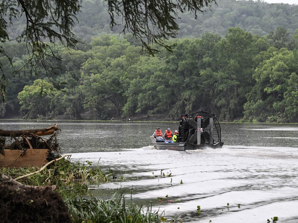 Men ride in an airboat on the Guadalupe River as they look for missing people in Hunt, Texas, on July 6, 2025, following severe flash flooding that occured during the July Fourth holiday weekend.