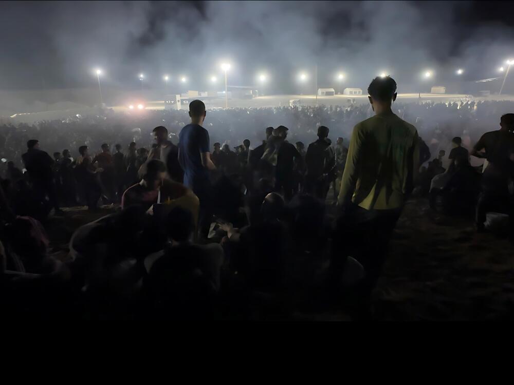Palestinians gather at a food distribution center run by the Gaza Humanitarian Foundation on June 24, 2025.