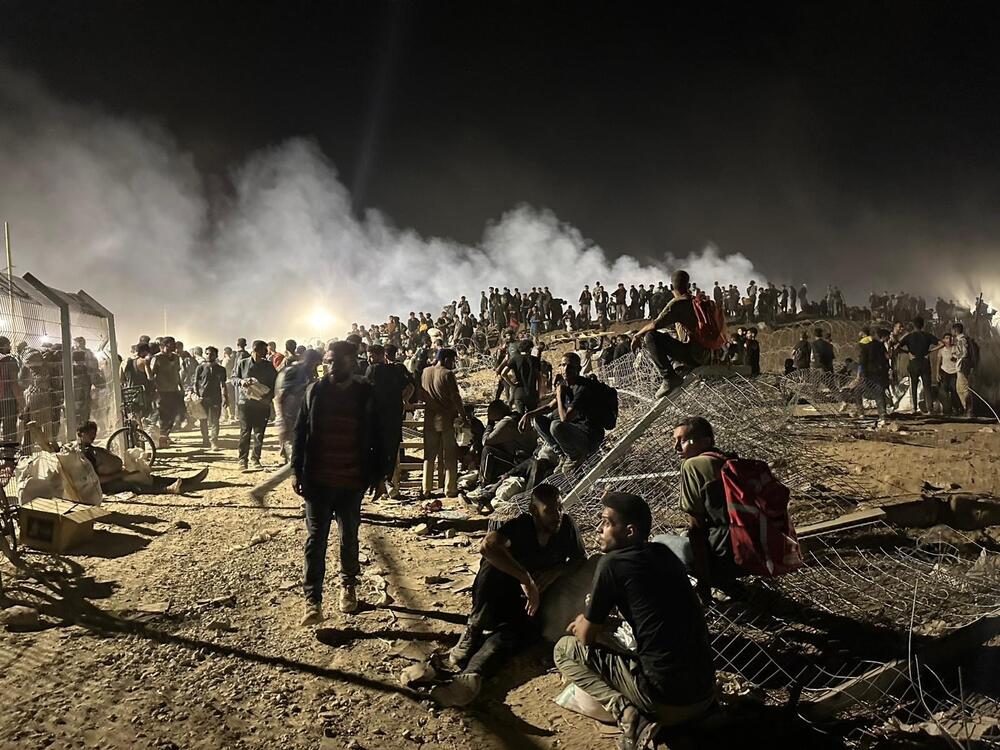 Palestinians gather at a food distribution center in central Gaza run by the Gaza Humanitarian Foundation on June 24, 2025.