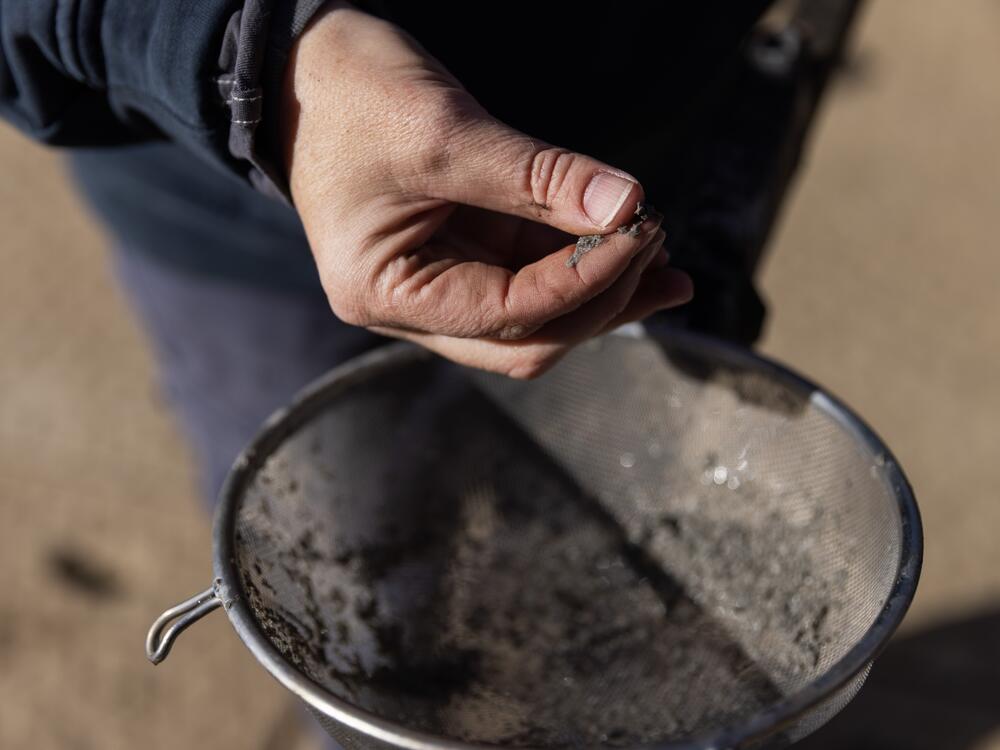 Amanda Veazey, vice president of business development at CSR Services, holds a strainer with bits of concrete that were drilled out of an orphan gas well in Ashland, Ohio, on October 24, 2024.