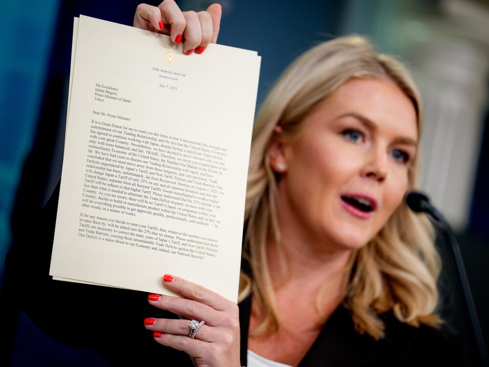 White House press secretary Karoline Leavitt holds up a copy of a letter to Japan, signed by President Trump, announcing 25% tariffs beginning on Aug. 1st, during the daily press briefing at the White House on July 7.