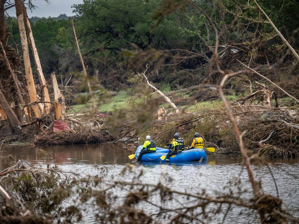 A search and recover unit paddles along the Guadalupe River on Monday in Hunt, Texas. Heavy rainfall caused severe flash flooding along the Guadalupe River in central Texas.
