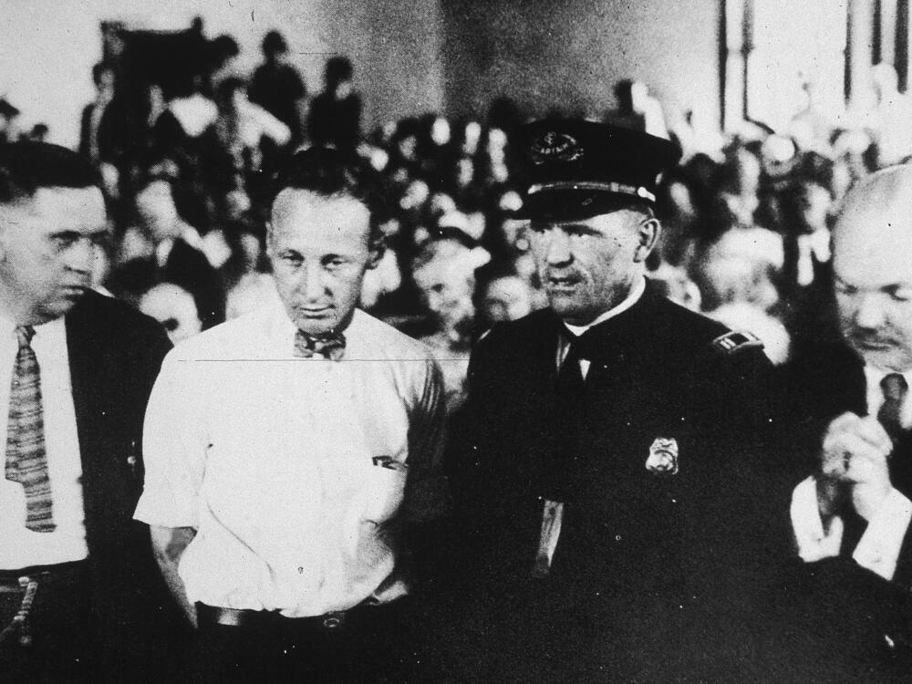 Teacher John Scopes, second from left, stands in the courtroom during his trial on charges of teaching Darwin's theory.