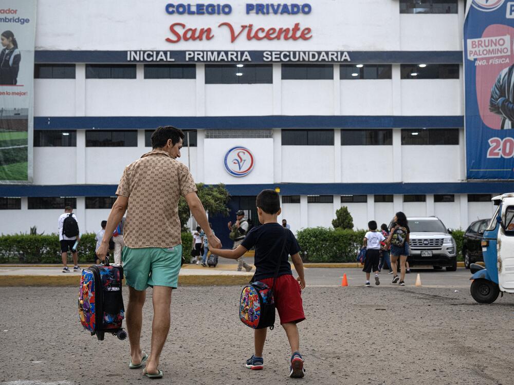 Parents drop off their children at the private San Vicente School in Lima, Peru, which was targeted for extortion, in April.