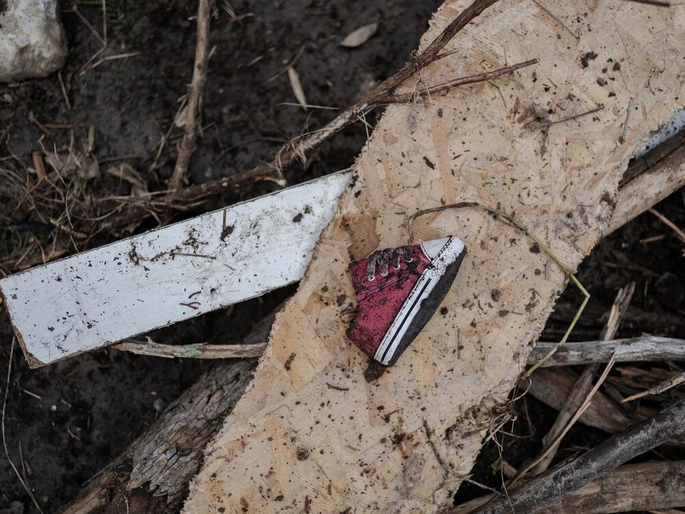 A baby shoe lays along the Guadalupe River after it was swept up in the flash flooding in Ingram, Texas.